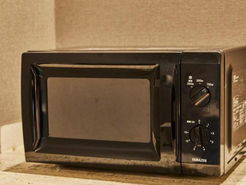 a black toaster oven sitting on top of a counter at Kansai Airport Washington Hotel in Izumi-Sano