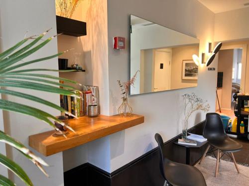 Cette chambre comprend un miroir, une table et des chaises. dans l'établissement Dizengoff 208 Hotel Tel Aviv, à Tel Aviv