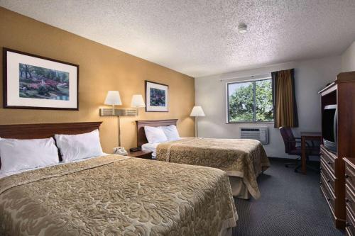 a hotel room with two beds and a window at Super 8 by Wyndham Canton/Livonia Area in Canton