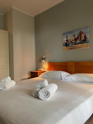 a bedroom with two beds with towels on them at Hotel l'Etrusco - San Vincenzo in San Vincenzo