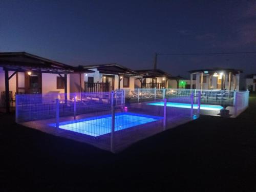 una piscina por la noche con luces azules en El Paraíso Perdido, en Conil de la Frontera