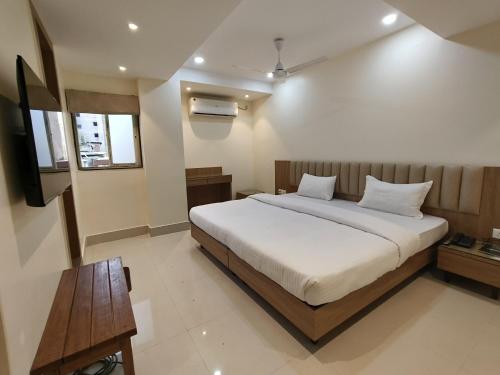 a bedroom with a bed and a television in it at HOTEL 11 JULY in Guwahati