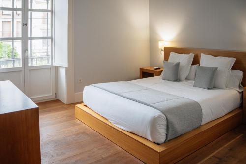 Postel nebo postele na pokoji v ubytování Hotel Boutique Palacio Corredera