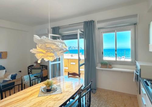 a dining room with a table with a view of the ocean at Solemar Sicilia - Casa Bella in Bagheria