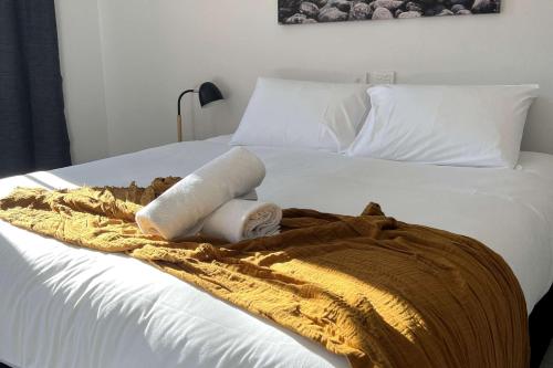 a bed with two towels and a blanket on it at Comfort Inn Centrepoint Motel in Lismore