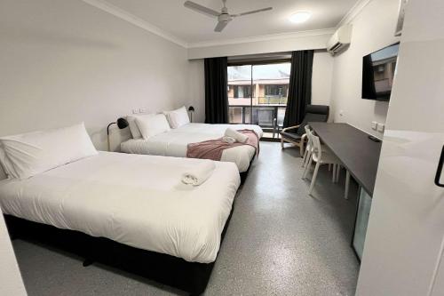 a hotel room with two beds and a desk at Comfort Inn Centrepoint Motel in Lismore