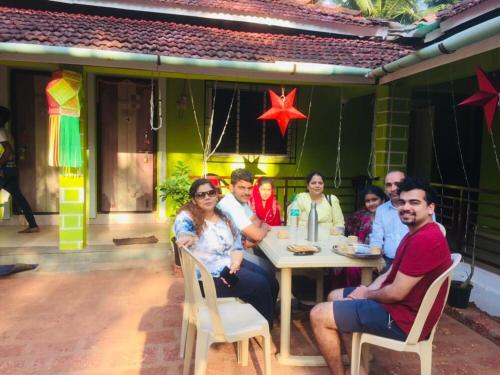 a group of people sitting at a table at Coco Hut , Devbaug in Malvan