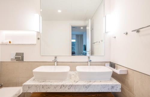 a bathroom with two sinks and a mirror at Vacay Lettings 2 Bed Retreat near Burj Al Arab in Dubai