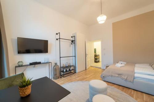 a living room with a bed and a flat screen tv at Delia Apartment I levestate in Vienna