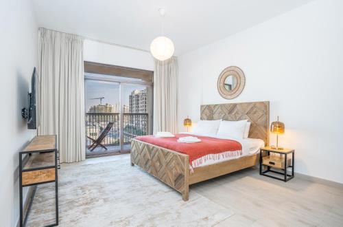 a bedroom with a bed and a large window at Vacay Lettings 2 Bed Retreat near Burj Al Arab in Dubai