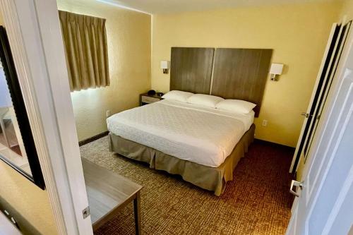 a bedroom with a bed in a hotel room at Suburban Studios Fort Myers Cape Coral in Fort Myers