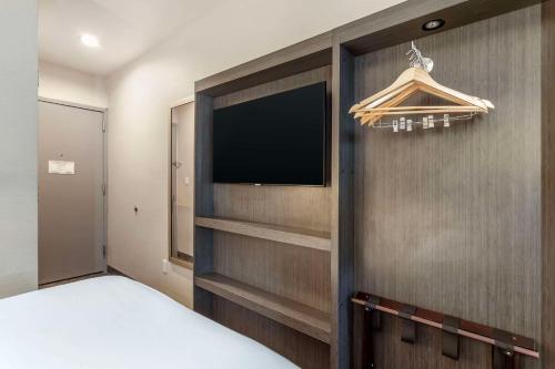 a bedroom with a flat screen tv on a wall at Comfort Inn Manhattan - Midtown West in New York