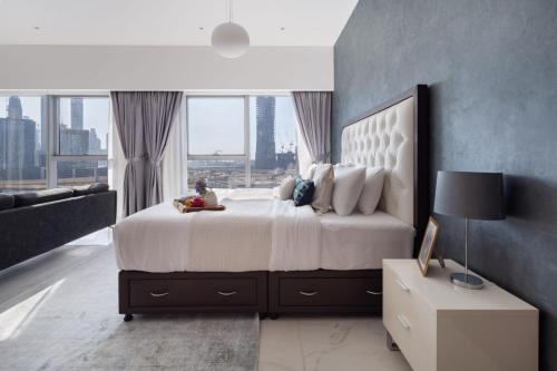 a bedroom with a large bed with a large window at Frank Porter - Central Park Towers in Dubai