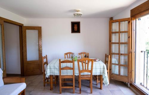 a dining room with a table and some chairs at Casa El Soldau in Naval