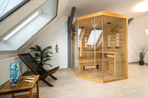 a room with a large wooden building with a table at Ferienhaus Hus Stine in Rechlin