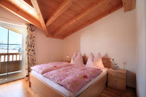 a bedroom with a bed and a large window at Appartement Angelika in Brixen im Thale