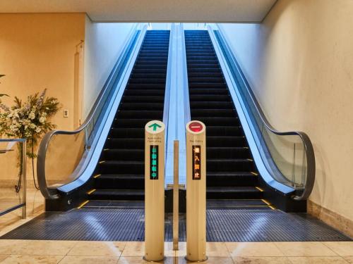 an escalator in a building with two escalators at Kansai Airport Washington Hotel in Izumi-Sano