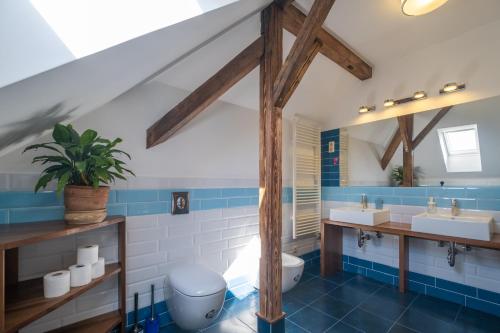 a bathroom with two sinks and a toilet at Giovanni's Airport House in Budapest
