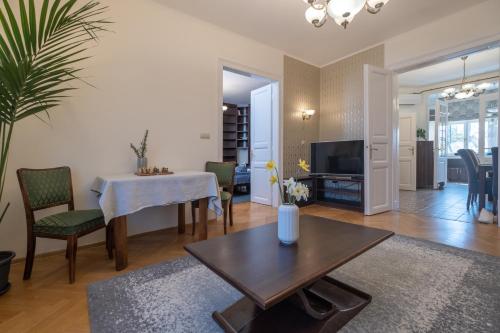 a living room with a table and a dining room at Giovanni's Airport House in Budapest