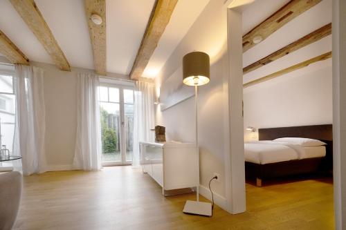a bedroom with a bed and a large window at Der Charlottenhof in Ahrenshoop