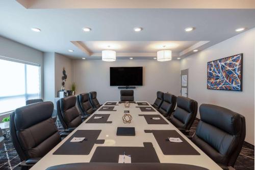 a conference room with a long table and chairs at Microtel Inn & Suites Dorval QC in Dorval