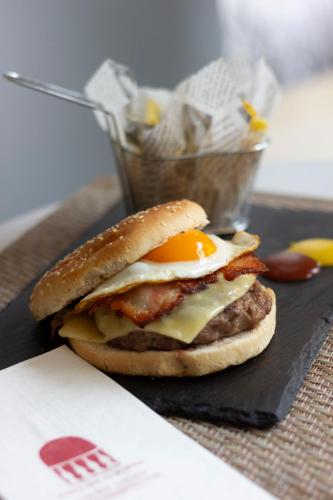 a breakfast sandwich with an egg on a bagel at Alborán Algeciras in Algeciras