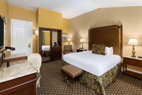 a hotel room with a large bed and a bathroom at The Lafayette by LuxUrban in New Orleans