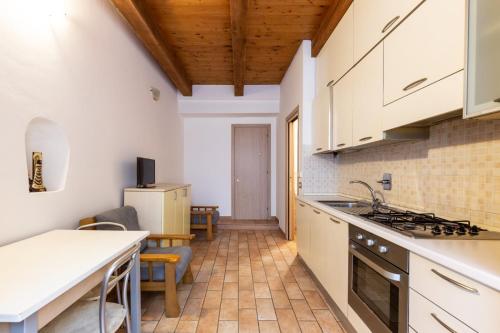 a kitchen with white cabinets and a counter top at Guest House da Generoso in Pesaro