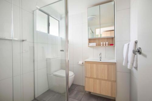 a bathroom with a toilet and a glass shower at Nightcap at Roxby Downs in Roxby Downs