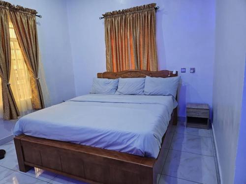 a bedroom with a large bed in a room at Glory Apartment in Ibadan