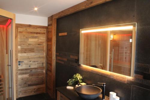 La salle de bains est pourvue d'un lavabo et d'un miroir. dans l'établissement Chalet Mont-Reve, à Font-Romeu-Odeillo-Via