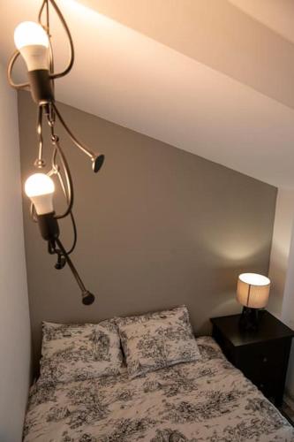 a bedroom with a bed with two lamps on it at Apartamento Rojo in Ateca
