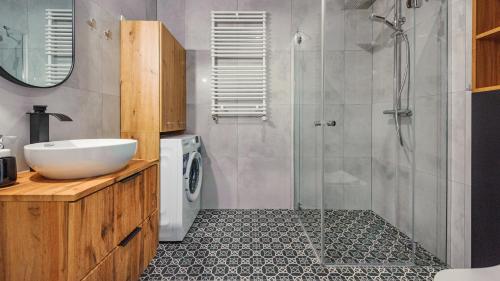 y baño con lavabo y ducha. en Apartamenty Sun & Snow Kuracyjna 15A en Jastrzębia Góra