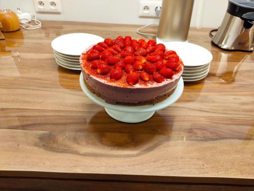a chocolate cake with strawberries on a table at LES JARDINS CELESTES in Saint-Genest-de-Bauzon