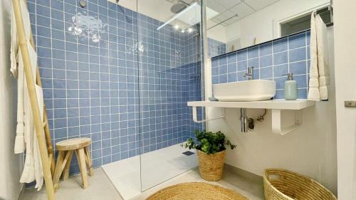 a bathroom with a sink and a blue tiled wall at La Alberca 16 in Denia