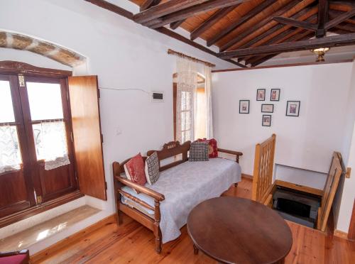 a living room with a table and a couch at Goulas Traditional Guesthouse in Monemvasia