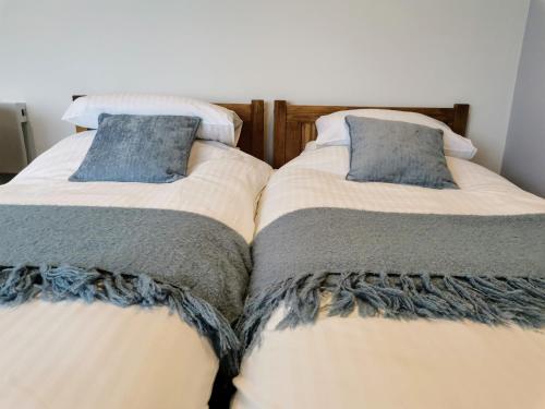 two beds sitting next to each other in a room at Harbour House Studio, Porlock Weir in Culbone