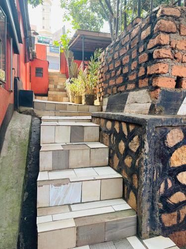 a set of stairs next to a stone wall at Zion guest house Kampala Uganda in Kampala
