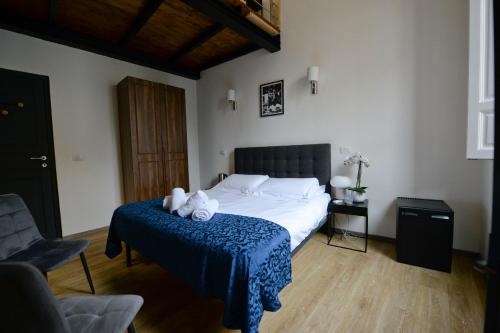 a bedroom with a bed with two teddy bears on it at Palazzo Oliveto in Florence