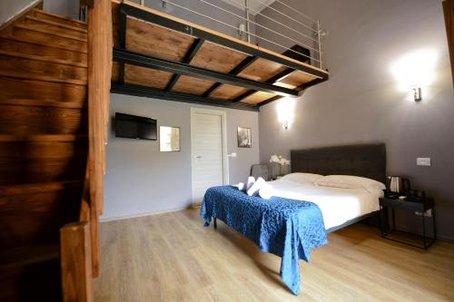 a bedroom with a bed with a blue blanket at Palazzo Oliveto in Florence