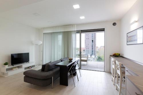 a living room with a couch and a table and a television at Terminal Tower 601 - San Cristoforo M4 in Milan