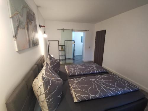 a living room with two beds and a couch at Airbnb, moderne, ruhige und helle Doppelzimmer, nähe Magdeburg, A14 & A2 in Dahlenwarsleben