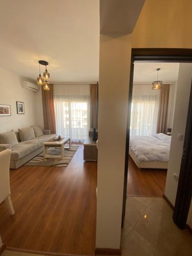 a living room with a couch and a bed at Dineta Flat Apartment in Ulcinj