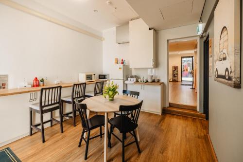 a kitchen and dining room with a table and chairs at Newtown Cozy Stays in Sydney