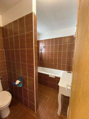 a bathroom with a toilet and a sink and a tub at Hôtel Le Soleil Couchant in Saint-Pierre