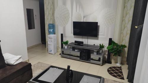 a living room with a flat screen tv on the wall at Mely homes in Ruiru