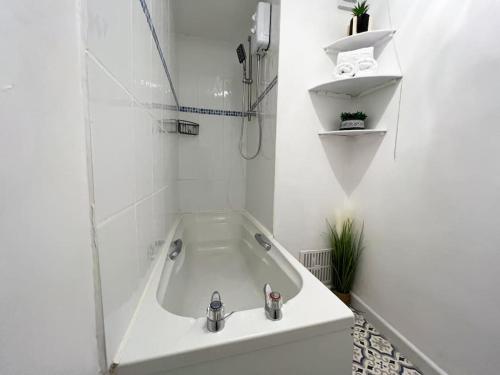 a white bathroom with a tub and a sink at Last minute discounts City Centre Business in Plymouth