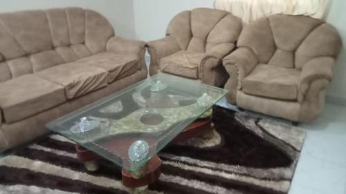 a living room with two chairs and a coffee table at FAVOURED EVAMAX in Eldoret