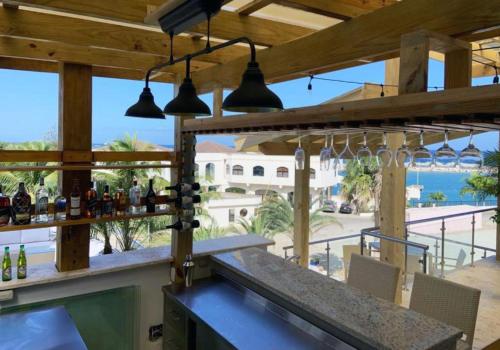 a bar with a view of the ocean at Cofresi Hills Residence in Gurapito
