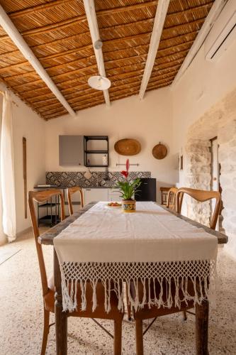 a table with a white table cloth on it in a kitchen at Casale Millinchè in Scicli